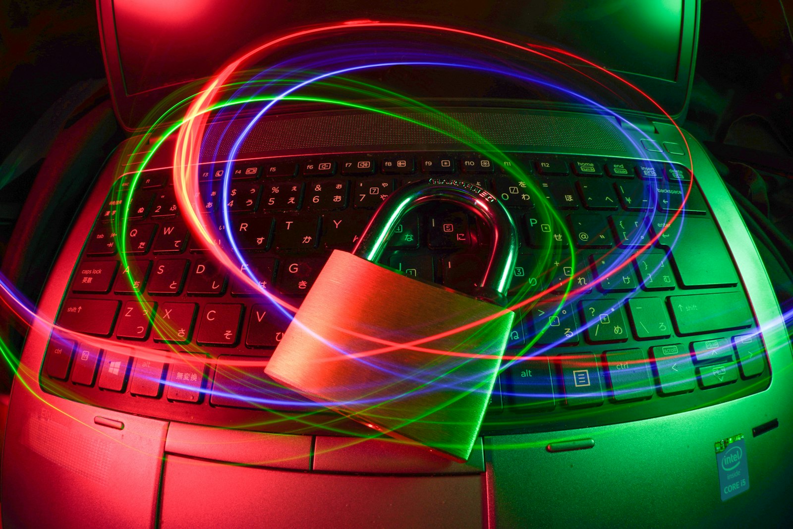 Padlock on a laptop with light trails representing cyber security
