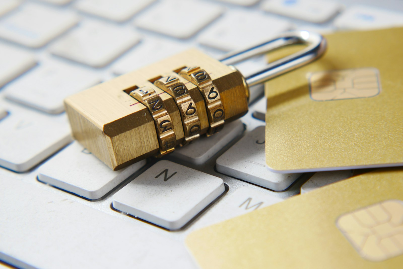 Gold padlock sitting on a computer keyboard
